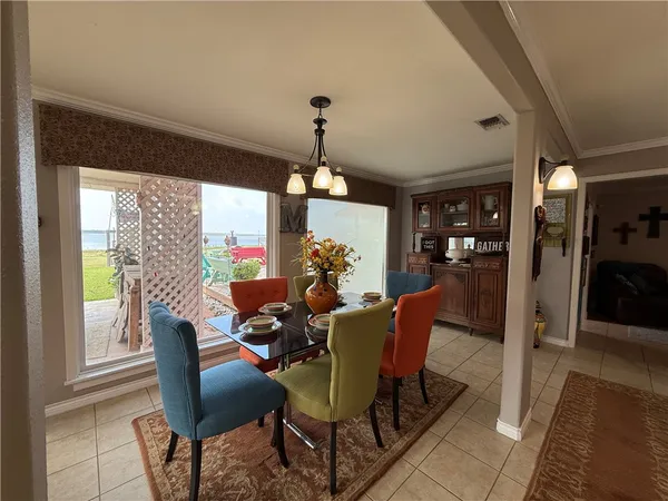 a dining room with furniture a chandelier and wooden floor