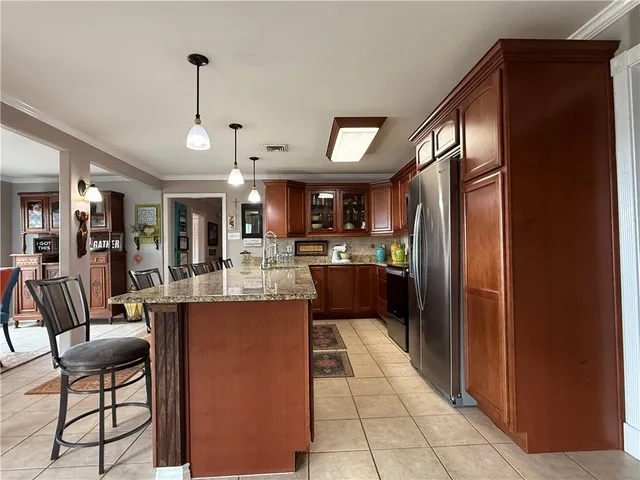 a kitchen with kitchen island granite countertop a table and chairs in it