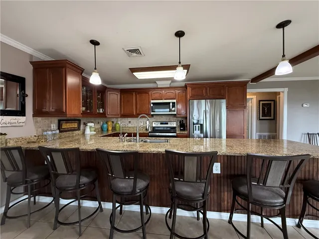 a view of a kitchen with kitchen island granite countertop a large counter top
