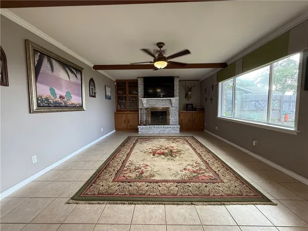 a living room with fireplace and a rug