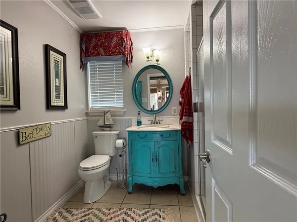 a bathroom with a toilet a sink and mirror
