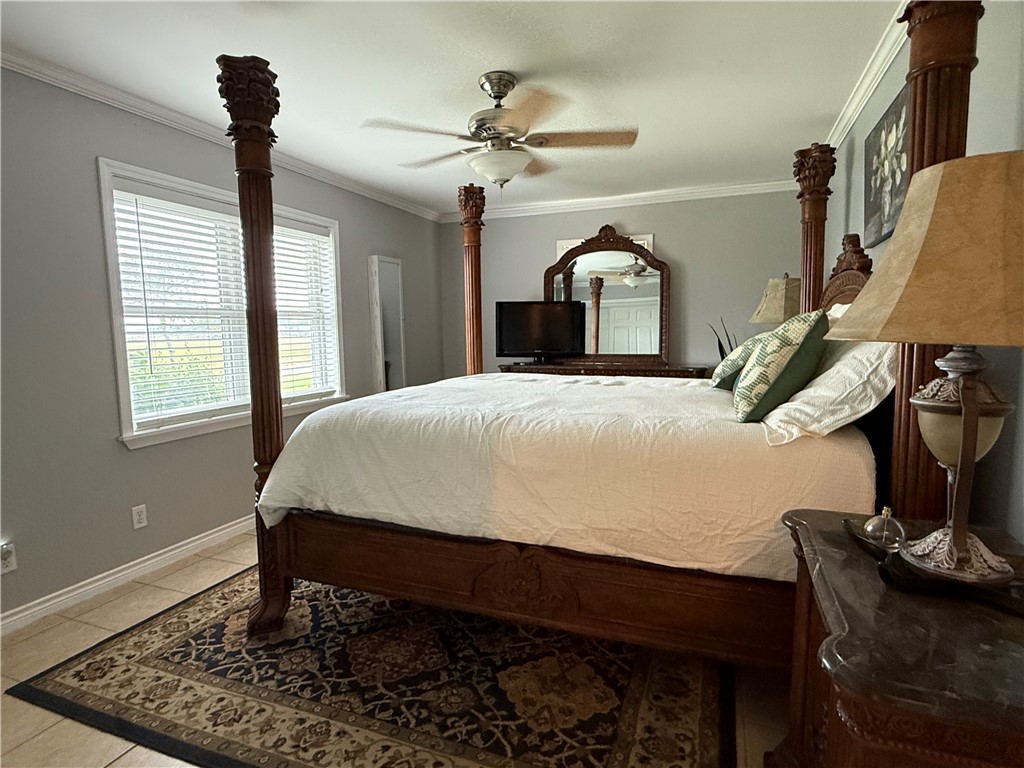 116 Sunset Drive Mathis, TX 78368 - Photo 28 of 40 a bedroom with a bed table and window