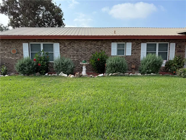 a view of a house with a backyard