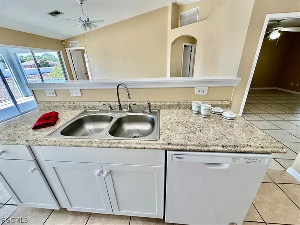 a utility room with sink and mirror