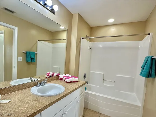 a toilet sitting next to a white wall