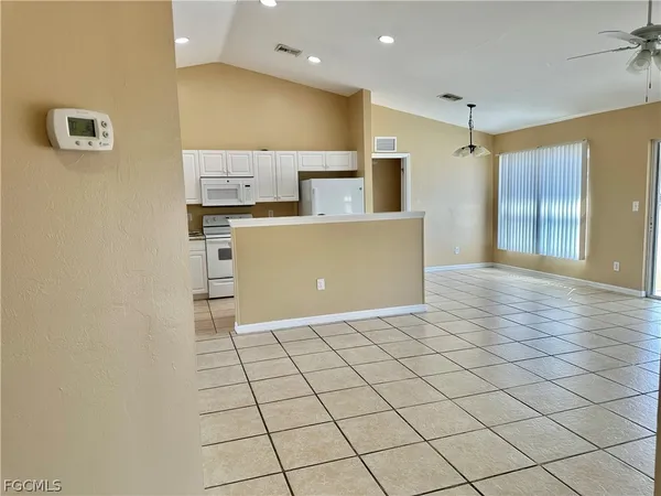 a view of an empty room with a floor to ceiling window