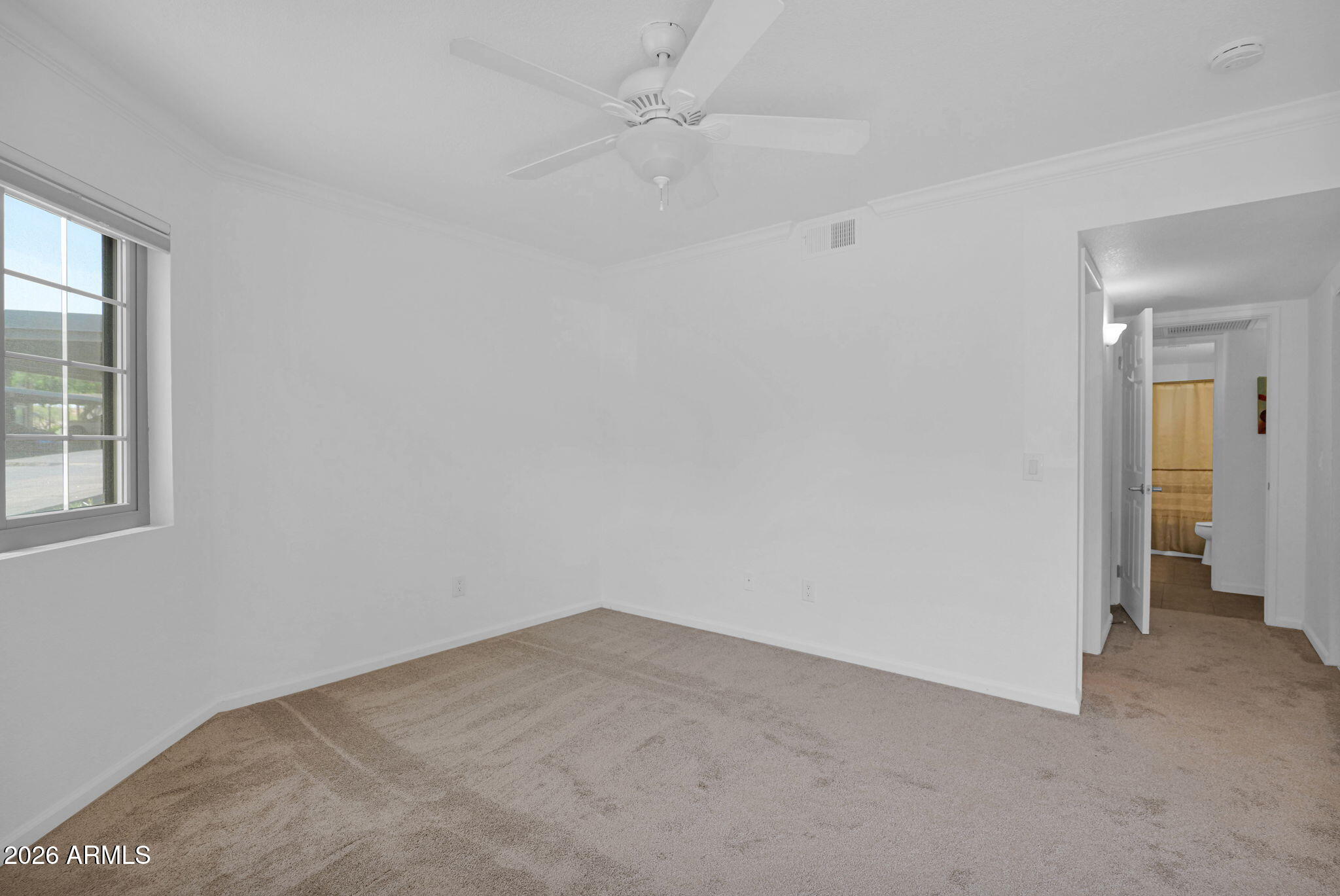 1720 East Thunderbird Road, Unit 1019 Phoenix, AZ 85022 - Photo 5 of 47 an empty room with a window and a ceiling fan