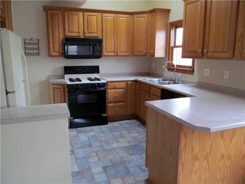 Kitchen. Great workspace and breakfast bar counter top.  Gas range, dishwasher, light oak cabinets, vaulted ceiling with skylight!  All professionally finished.