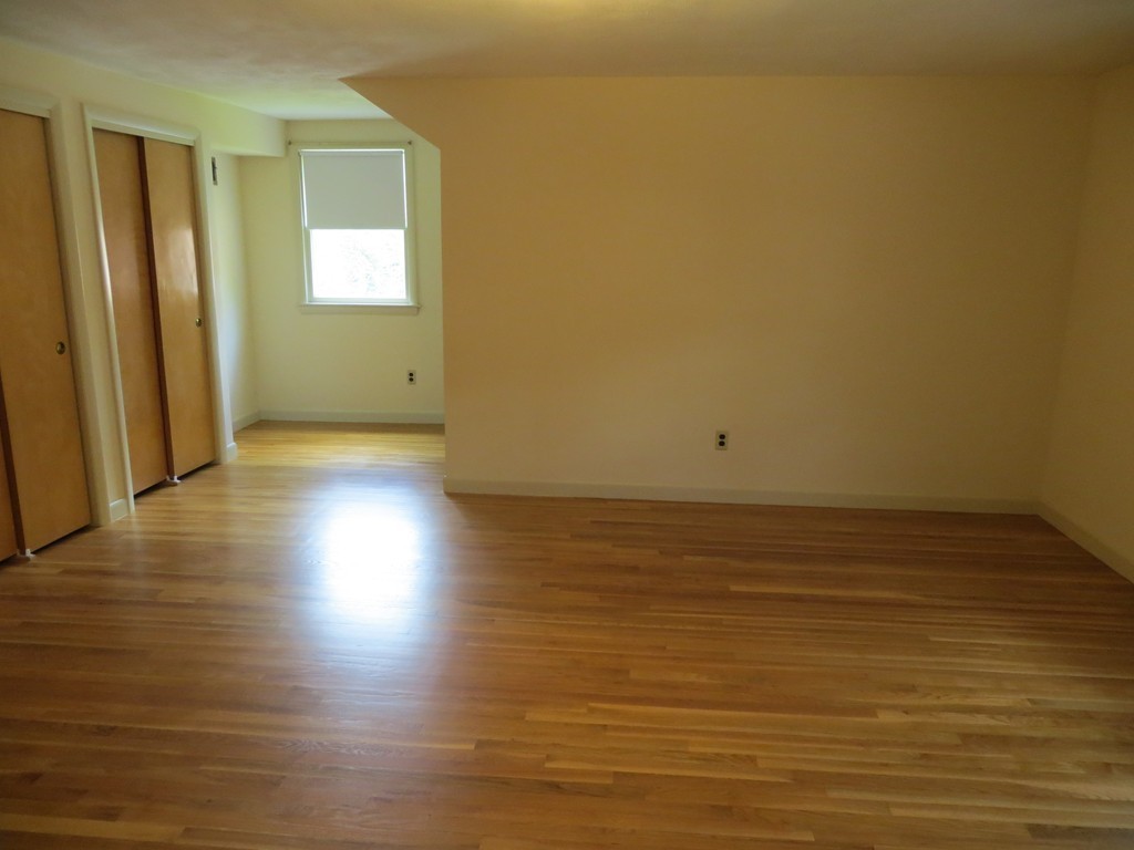 197 Gardner Road Brookline, MA 02445 - Photo 20 of 30 a view of a room with wooden floor and brick walls