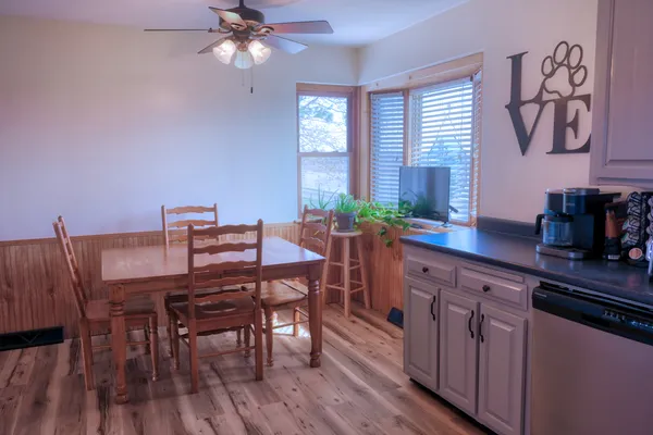 a kitchen with a table chairs and cabinets