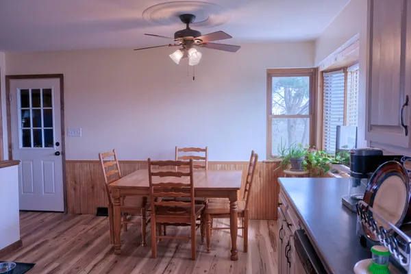 a view of a dining room with furniture and chandelier