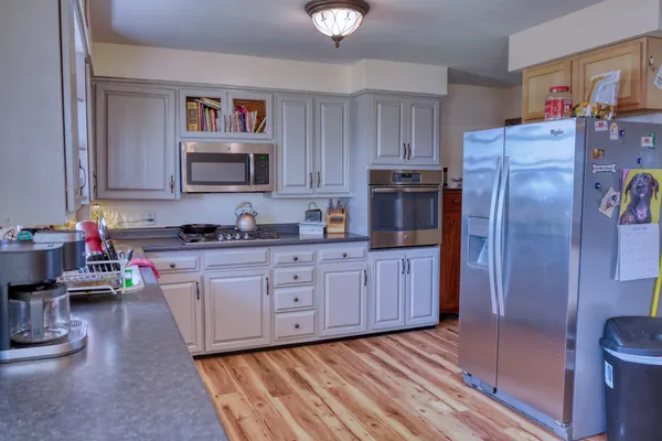 a kitchen with stainless steel appliances granite countertop a refrigerator sink and cabinets