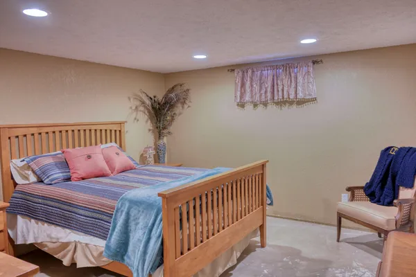 a bedroom with bed and a couch