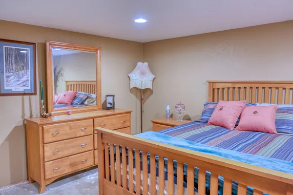 a bedroom with a bed and a dresser in it