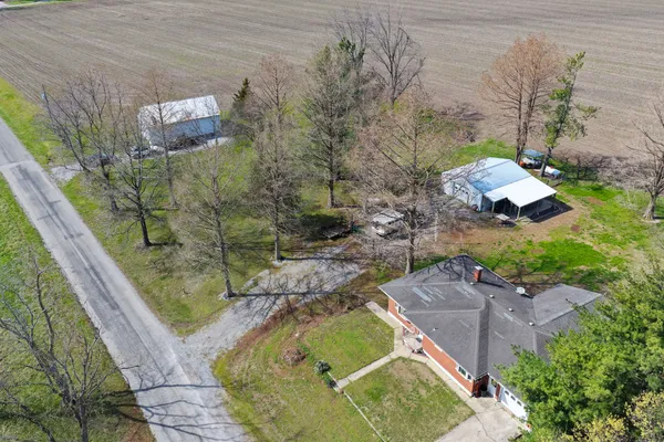 an aerial view of a house with a yard and swimming pool