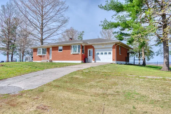 a front view of house with yard and green space