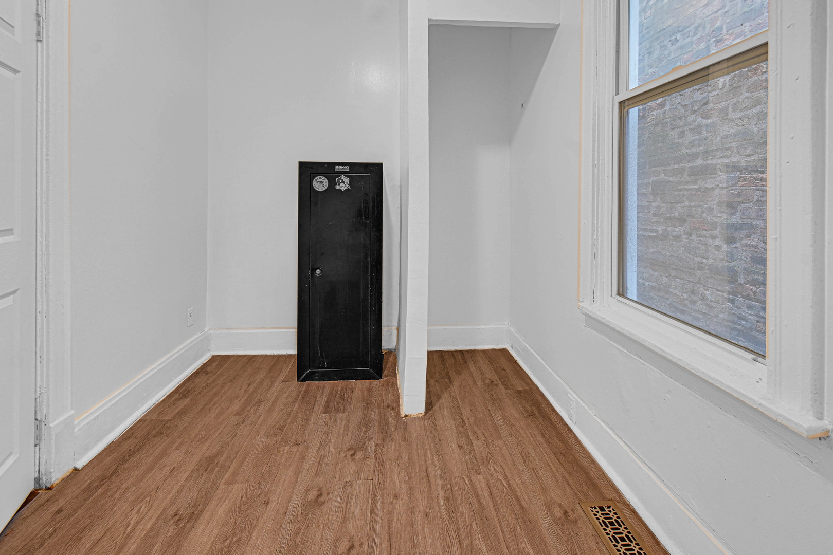 5607 South Laflin Street Chicago, IL 60636 - Photo 11 of 17 a view of an empty room with wooden floor