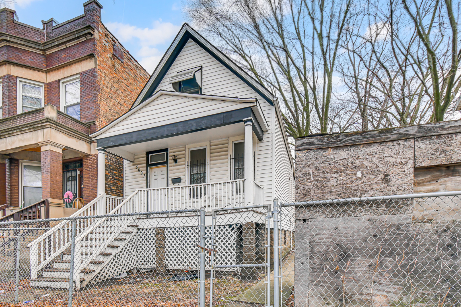 5607 South Laflin Street Chicago, IL 60636 - Photo 2 of 17 front view of a house with a bench