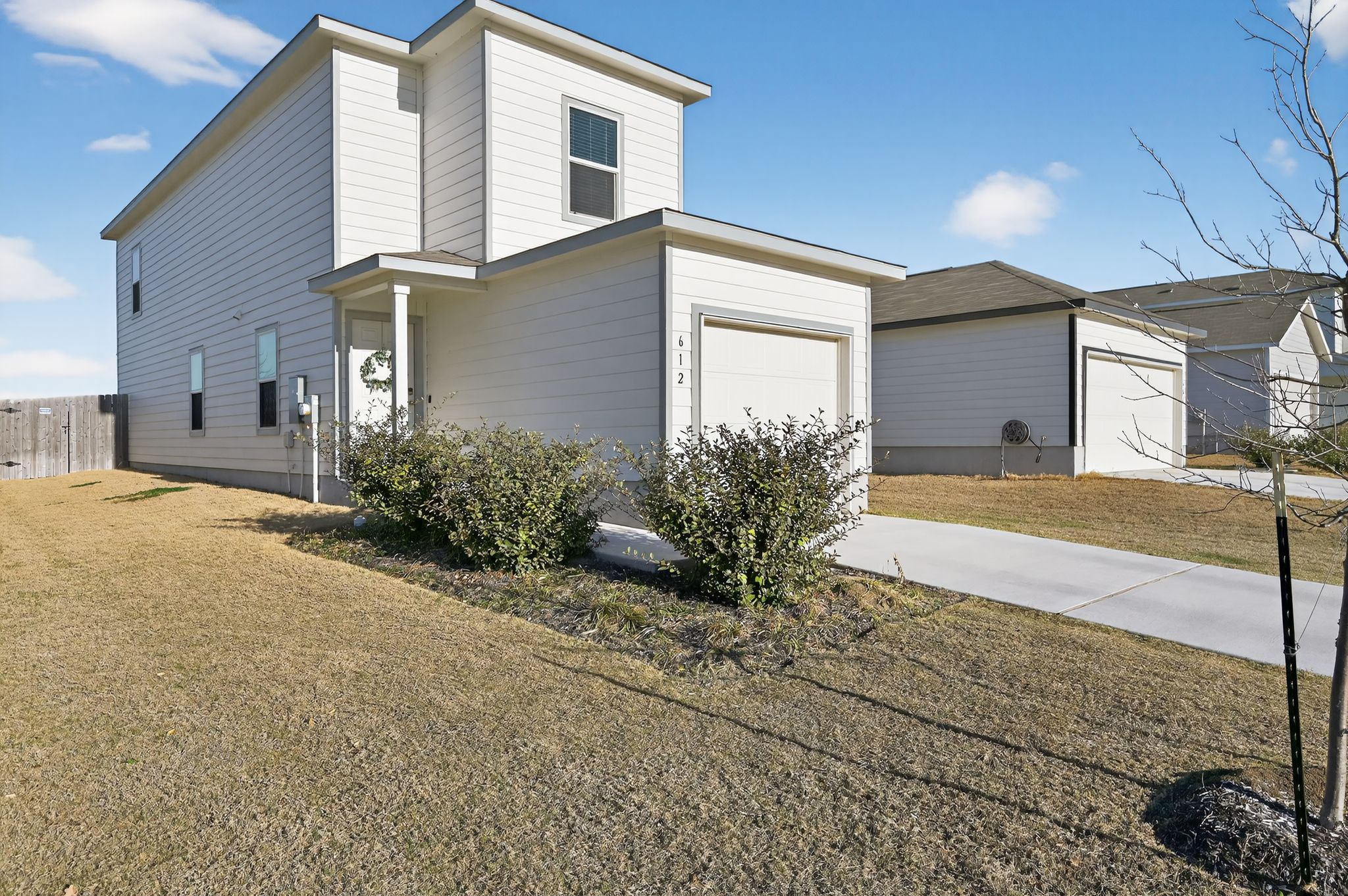 612 Marty Allen Loop Jarrell, TX 76537 - Photo 2 of 15 View of front facade featuring an attached garage and concrete driveway