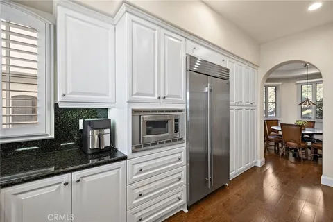 a kitchen with stainless steel appliances granite countertop a refrigerator and a stove top oven