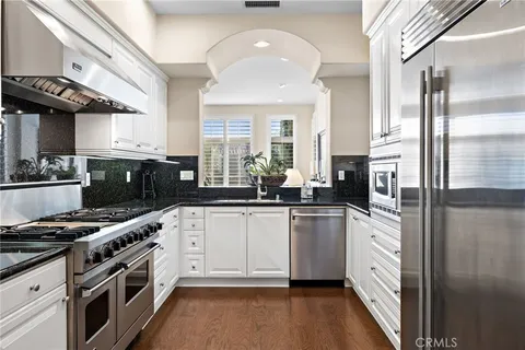 a kitchen with stainless steel appliances a stove a sink and a refrigerator