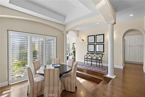 a dining room with furniture and wooden floor