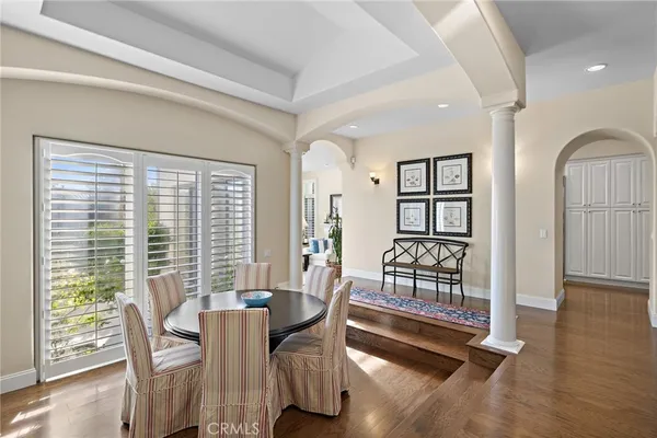a dining room with furniture and wooden floor