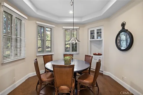 a dining room with furniture a rug and a window