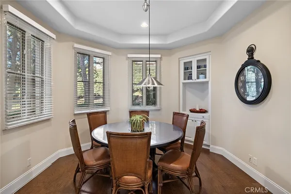a dining room with furniture a rug and a window