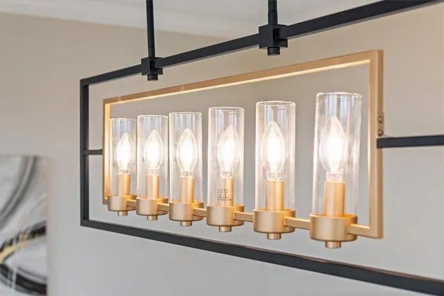 a view of a room with large windows and furniture