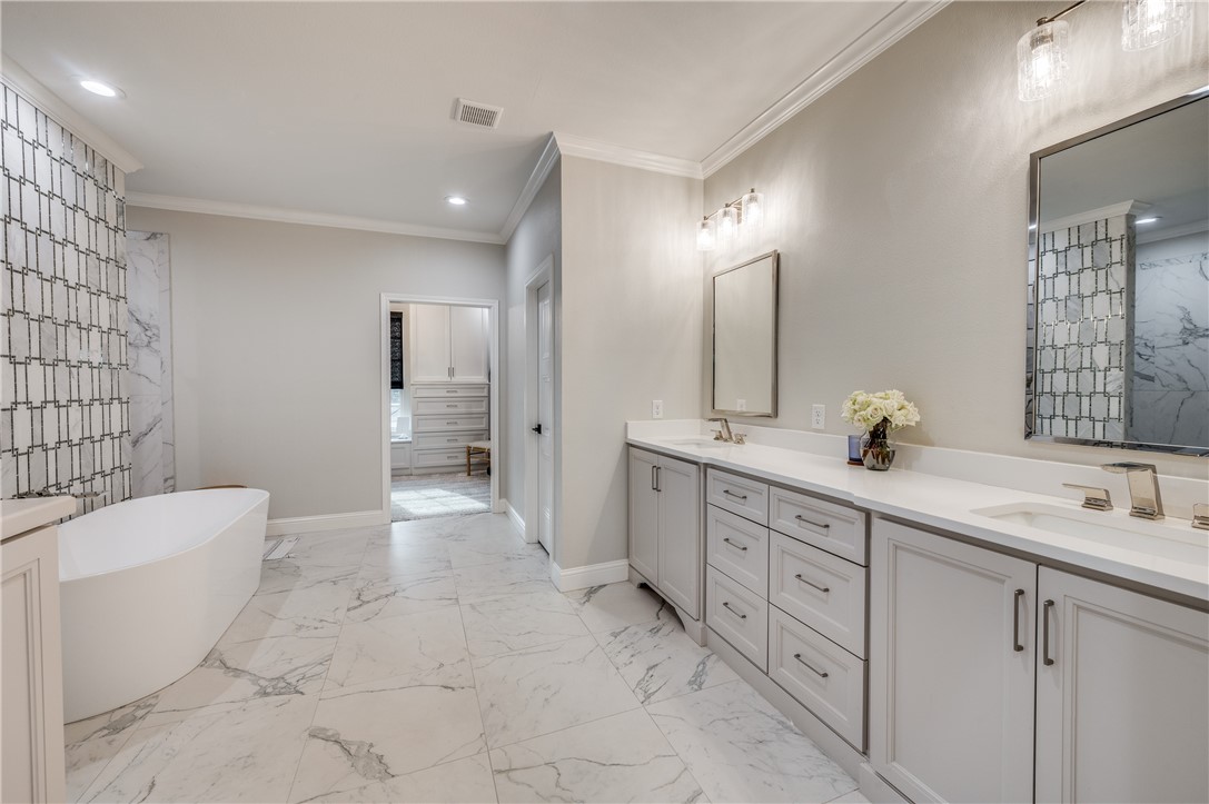164 Water View Lane Robinson, TX 76706 - Photo 17 of 26 a spacious bathroom with a double vanity sink a toilet a mirror and shower