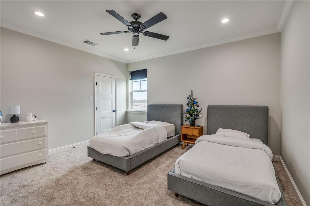 164 Water View Lane Robinson, TX 76706 - Photo 21 of 26 a spacious bedroom with two bed and a chandelier
