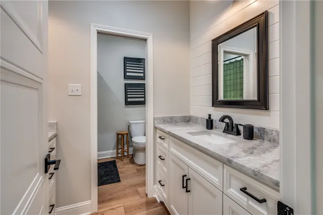 a bathroom with a granite countertop sink and a mirror