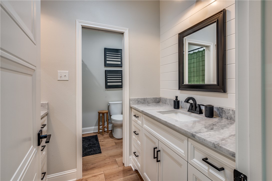 164 Water View Lane Robinson, TX 76706 - Photo 22 of 26 a bathroom with a granite countertop sink and a mirror