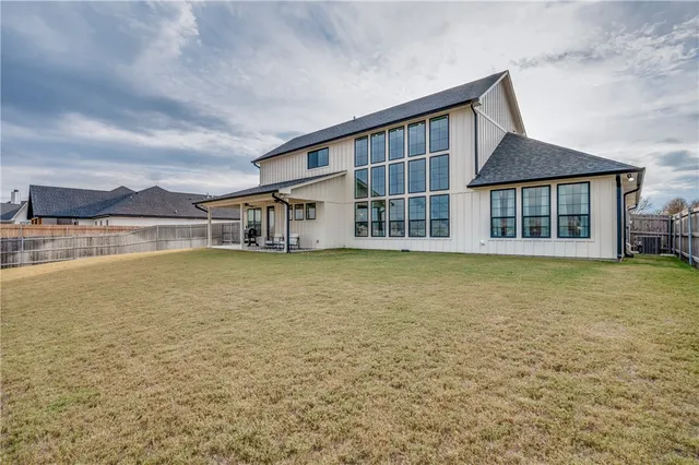 a house view with swimming pool in front of it
