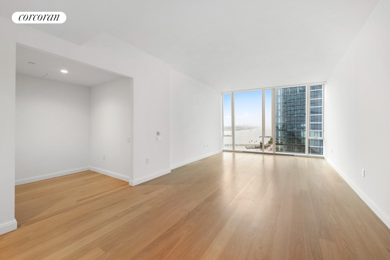 10 Riverside Boulevard, Unit 27C Manhattan, NY 10069 - Photo 2 of 14 an empty room with wooden floor and windows