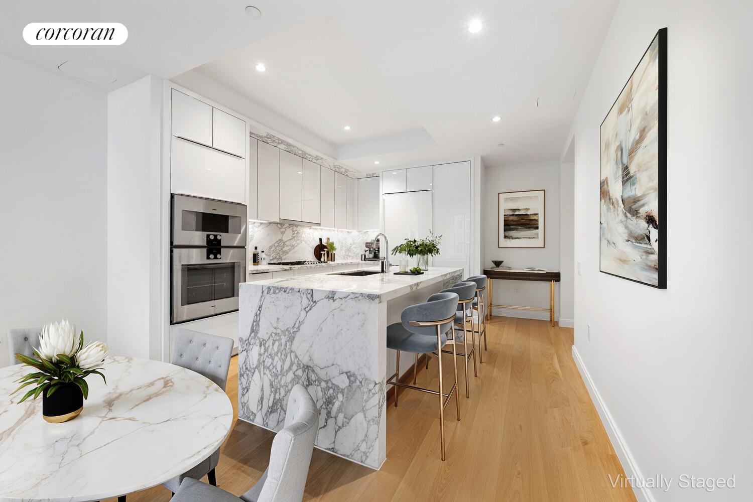 10 Riverside Boulevard, Unit 27C Manhattan, NY 10069 - Photo 3 of 14 a kitchen with stainless steel appliances a dining table chairs and granite counter tops