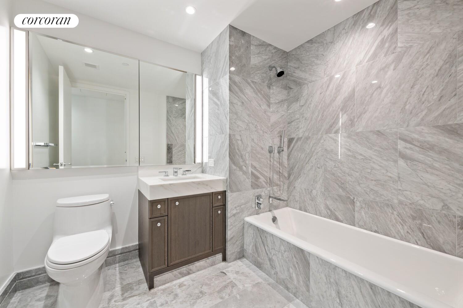 10 Riverside Boulevard, Unit 27C Manhattan, NY 10069 - Photo 9 of 14 a bathroom with a bathtub shower sink mirror and toilet