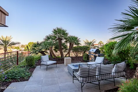 a view of a patio with table and chairs and potted plants