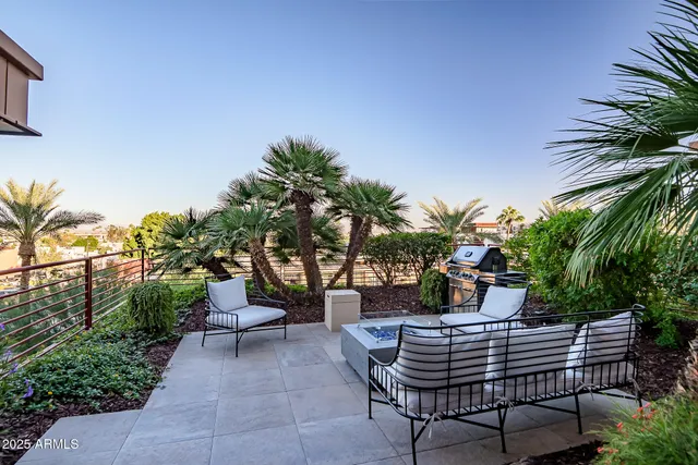 a view of a patio with table and chairs and potted plants