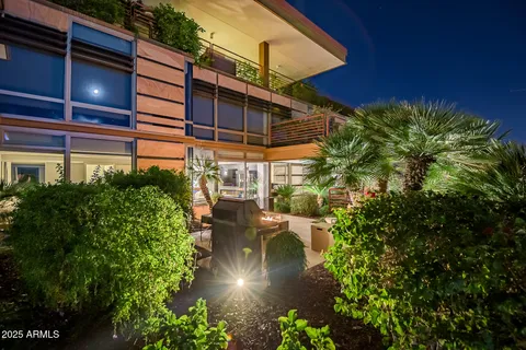 a kitchen with a dining table chairs and wooden floor