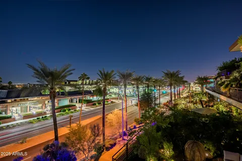 a kitchen with stainless steel appliances kitchen island granite countertop a refrigerator a sink a stove and white cabinets with wooden floor