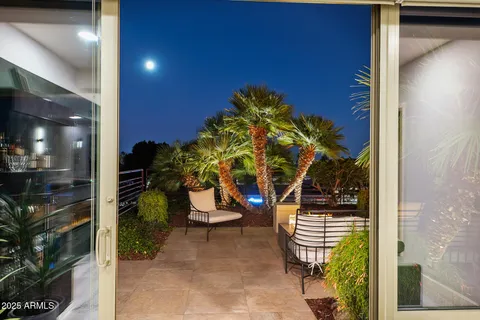 a living room with large window and furniture