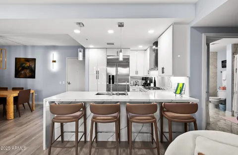 a bedroom with a bed and a flat tv screen on dresser