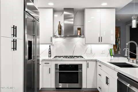 a living room with lots of furniture and a large window