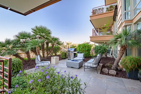 a backyard of a house with fire pit and outdoor seating