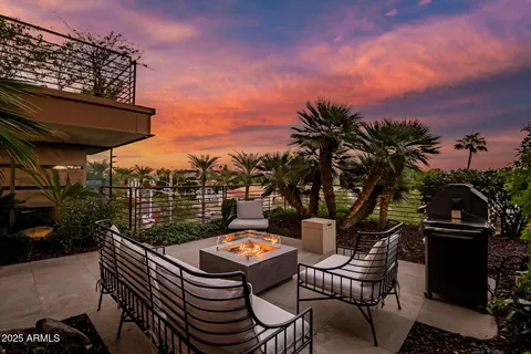 a living room with furniture a floor to ceiling window and a flat screen tv