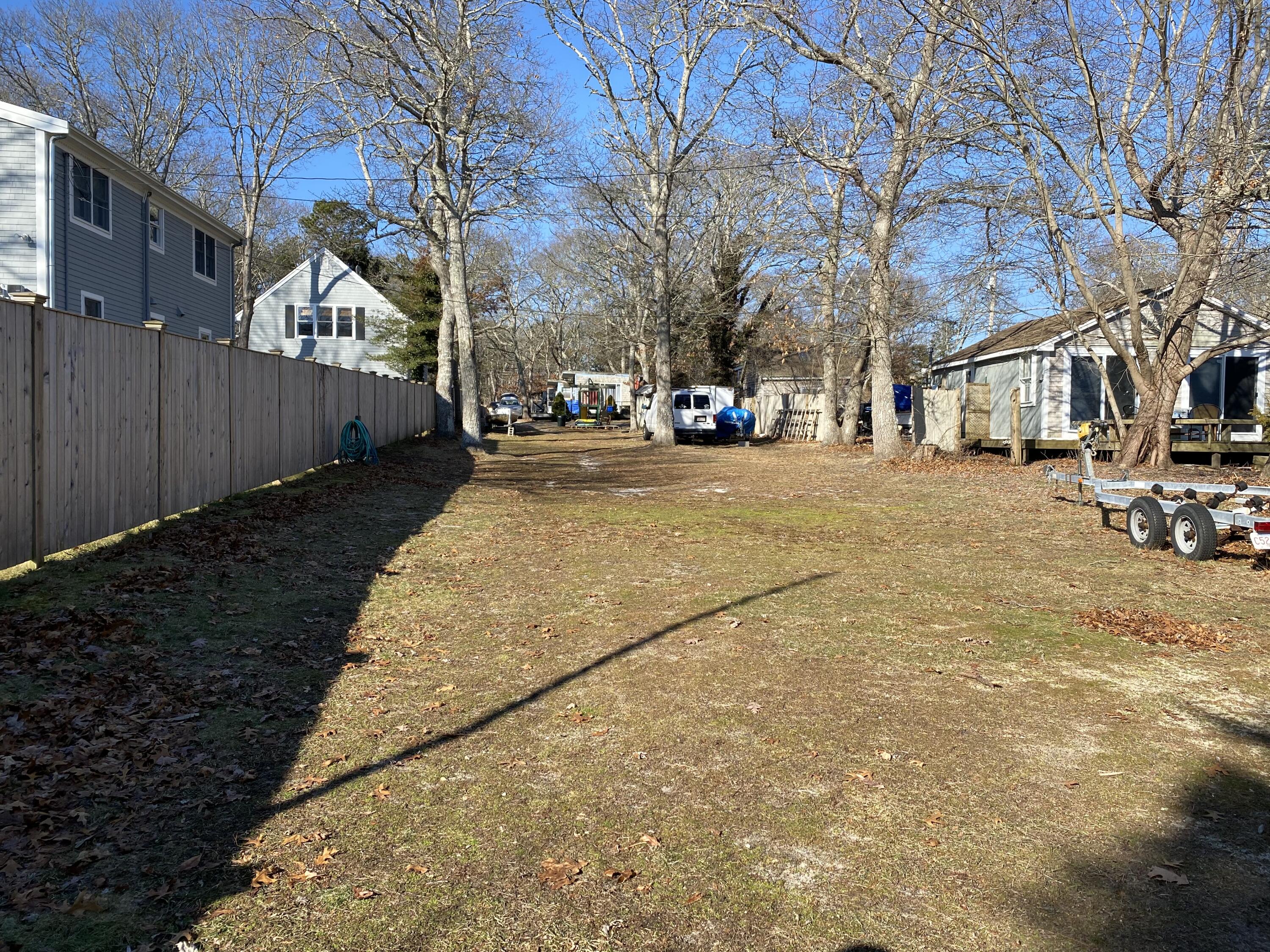 49 Riverside Road Mashpee, MA 02649 - Photo 5 of 8 a street view with residential house