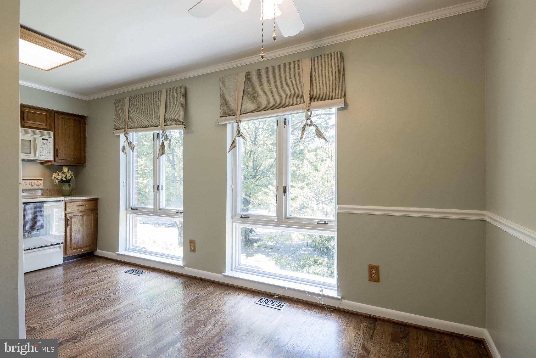 627 South Hanover Street Baltimore, MD 21230 - Photo 14 of 41 a view of an empty room with a window and wooden floor