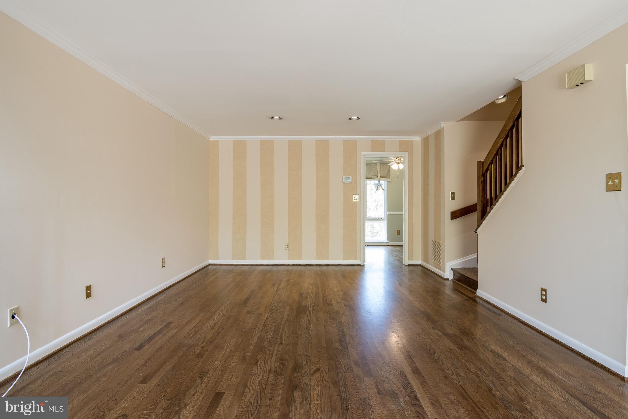 627 South Hanover Street Baltimore, MD 21230 - Photo 17 of 41 a view of an empty room with wooden floor and a window